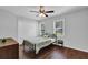 Simple bedroom with bed, ceiling fan, and view of the outdoor foliage at 5515 Pennybrook Trl, Stone Mountain, GA 30087