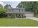 Charming two-story home with a well-manicured lawn, inviting front porch, and attached two-car garage at 5515 Pennybrook Trl, Stone Mountain, GA 30087