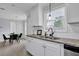 Bright kitchen with granite countertops, stainless sink, white cabinets and window with natural light at 5515 Pennybrook Trl, Stone Mountain, GA 30087