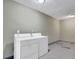 A simple laundry room featuring a standard washer and dryer set, with ample space around the units at 5515 Pennybrook Trl, Stone Mountain, GA 30087