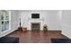 Living area with wood flooring, fireplace and natural light from the window at 5515 Pennybrook Trl, Stone Mountain, GA 30087