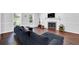 Spacious living room featuring a dark sofa, fireplace, and large windows for ample natural light at 5515 Pennybrook Trl, Stone Mountain, GA 30087