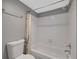 Tiled bathroom with a tub, toilet, shower, and shower curtain at 764 Patterns Sw Dr, Mableton, GA 30126