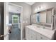 Bathroom featuring modern vanity, large mirror, and an open doorway to the bedroom at 764 Patterns Sw Dr, Mableton, GA 30126