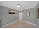 Spacious bedroom featuring tiled floors, crown molding, and natural light from a large window at 764 Patterns Sw Dr, Mableton, GA 30126