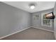 Neutral bedroom featuring cozy carpet, modern lighting, and a mounted television at 764 Patterns Sw Dr, Mableton, GA 30126