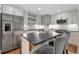 Modern kitchen with stainless steel appliances, island with seating, and stylish backsplash at 764 Patterns Sw Dr, Mableton, GA 30126
