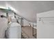 Functional laundry room with washer, dryer, and ample storage on wall-mounted shelving at 764 Patterns Sw Dr, Mableton, GA 30126