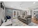 Open-concept living room with a plush sofa, hardwood floors, and access to outdoor space at 764 Patterns Sw Dr, Mableton, GA 30126