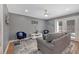 Comfortable living room with a modern ceiling fan, stylish furniture, and hardwood floors at 764 Patterns Sw Dr, Mableton, GA 30126