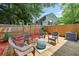 Relaxing wooden patio with wicker furniture, surrounded by a privacy fence and lush greenery at 764 Patterns Sw Dr, Mableton, GA 30126