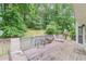 A wooden deck is equipped with outdoor furniture, offering a relaxing view of the wooded backyard at 1101 Parkland Se Run, Smyrna, GA 30082