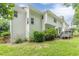 White exterior with a wooden deck and green backyard, partially shaded by mature trees at 1101 Parkland Se Run, Smyrna, GA 30082
