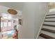 Basement featuring wood stairs, painted walls, decor, and a doorway leading to an exercise area with colorful flooring at 1101 Parkland Se Run, Smyrna, GA 30082