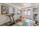 Basement exercise area featuring gym equipment, pennants, and a door leading to the outside at 1101 Parkland Se Run, Smyrna, GA 30082
