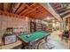 Finished basement with exposed ceiling, pool table, bar stools, and shelving, perfect for entertaining guests at 1101 Parkland Se Run, Smyrna, GA 30082