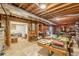 Unfinished basement area featuring a billiards room, shelving, decor, and exposed ceiling beams at 1101 Parkland Se Run, Smyrna, GA 30082