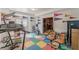 Basement exercise area with colorful floors, fitness equipment, pennants, and a doorway to another room at 1101 Parkland Se Run, Smyrna, GA 30082