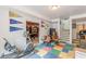 Basement area with colorful flooring, exercise equipment, pennants, and an entrance to a billiards room at 1101 Parkland Se Run, Smyrna, GA 30082