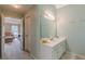 Bathroom with a sink, vanity, and doorway leading to the living room at 1101 Parkland Se Run, Smyrna, GA 30082