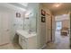 Bright bathroom featuring a vanity with drawers, a large mirror, and an open doorway to an adjacent bedroom at 1101 Parkland Se Run, Smyrna, GA 30082