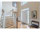 Elegant foyer with hardwood floors, staircase, and natural light streaming in from the front door at 1101 Parkland Se Run, Smyrna, GA 30082