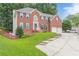 Lovely two-story red brick home featuring an attached two-car garage and manicured lawn at 1101 Parkland Se Run, Smyrna, GA 30082