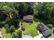 Aerial view of the property featuring a well-maintained lawn, mature trees and additional building at 1324 Concord Sw Cir, Lilburn, GA 30047