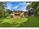 Backyard view of house featuring lush lawn, deck, mature trees, and a private, serene setting at 1324 Concord Sw Cir, Lilburn, GA 30047