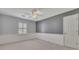 Bedroom with gray accent wall, white trim, ceiling fan, neutral carpet, and a shuttered window at 1324 Concord Sw Cir, Lilburn, GA 30047