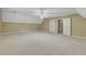Large bonus room with neutral carpet, light yellow walls, white ceiling, and three doors at 1324 Concord Sw Cir, Lilburn, GA 30047