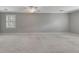 Spacious bonus room with carpet flooring, natural light and neutral paint at 1324 Concord Sw Cir, Lilburn, GA 30047