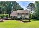 Charming two-story home with brick facade, lush landscaping, and a well-manicured lawn at 1324 Concord Sw Cir, Lilburn, GA 30047