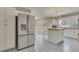 Spacious kitchen with stainless steel refrigerator, island with breakfast bar, and plentiful cabinet storage at 1324 Concord Sw Cir, Lilburn, GA 30047