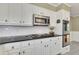 Well-equipped kitchen with stainless appliances, white cabinets, and ample counter space for cooking and storage at 1324 Concord Sw Cir, Lilburn, GA 30047