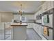 Bright kitchen featuring a center island, white cabinets, stainless steel appliances, and ample counter space at 1324 Concord Sw Cir, Lilburn, GA 30047