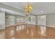 Spacious living room featuring hardwood floors, a decorative chandelier, and plenty of natural light at 1324 Concord Sw Cir, Lilburn, GA 30047