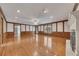 Large living room with hardwood floors, fireplace, and wood paneling at 1324 Concord Sw Cir, Lilburn, GA 30047