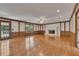 Cozy living room featuring hardwood floors, fireplace, and wood-paneled walls at 1324 Concord Sw Cir, Lilburn, GA 30047