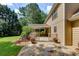 Beautiful stone patio with a covered deck, lush green lawn and flower pot decorations at 1324 Concord Sw Cir, Lilburn, GA 30047