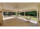 Spacious covered porch with wood floor, ceiling fan, swing, and landscaped backyard at 1324 Concord Sw Cir, Lilburn, GA 30047