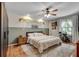 Well-lit main bedroom with hardwood floors, fan, and decor at 2716 Meadow Ridge Nw Dr, Duluth, GA 30096