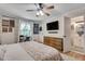 Comfortable bedroom with hardwood floors, side table, decor, and an adjoining bathroom at 2716 Meadow Ridge Nw Dr, Duluth, GA 30096