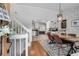 Open-concept dining room featuring hardwood floors, modern lighting, and easy access to the kitchen and staircase at 2716 Meadow Ridge Nw Dr, Duluth, GA 30096