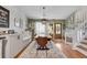 Bright dining room featuring stylish decor, hardwood floors, staircase access, and comfortable built-in bench seating at 2716 Meadow Ridge Nw Dr, Duluth, GA 30096