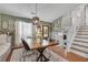 Charming dining room with hardwood floors, a rustic table, and convenient access to the staircase at 2716 Meadow Ridge Nw Dr, Duluth, GA 30096