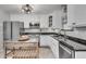 Bright kitchen featuring white cabinets, granite counters, stainless steel appliances, and herringbone backsplash at 2716 Meadow Ridge Nw Dr, Duluth, GA 30096