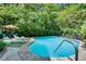 Inviting backyard pool with lounge seating, lush landscaping, and ample space for relaxation and entertainment at 2716 Meadow Ridge Nw Dr, Duluth, GA 30096