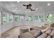 Bright sunroom with wood-paneled walls, large windows, and comfortable seating, perfect for relaxation at 2716 Meadow Ridge Nw Dr, Duluth, GA 30096
