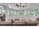 Relaxing sunroom with white wood paneling, ceiling fan, and an abundance of natural light through multiple windows at 2716 Meadow Ridge Nw Dr, Duluth, GA 30096